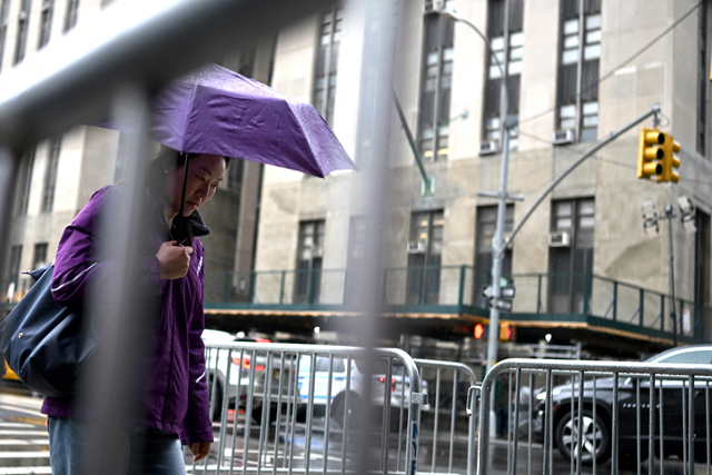 A woman walks past the Manhattan District Attorney's office in New York City, on Thursday (AFP photo)