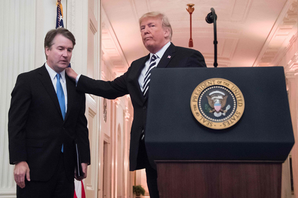   In this file photo taken on October 8, 2018, US President Donald Trump (right) pats Associate Justice of the US Supreme Court Brett Kavanaugh on the back during a ceremonial swear-in at the White House in Washington, DC (AFP photo)