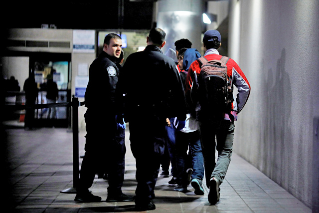 Unaccompanied minors, part of a caravan of thousands from central America trying to reach the United States, are escorted by US Customs and Border Protection officers as they are processed for asylum at the Otay Mesa Port of entry in San Diego, California, on December 17 (Reuters photo)