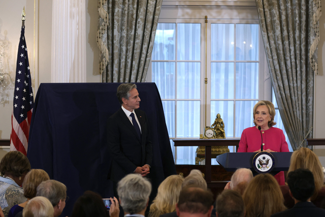Former US Secretary of State Hillary Clinton speaks as Secretary of State Antony Blinken listens during an unveiling of her portrait at the State Department on Tuesday in Washington, DC (AFP photo)