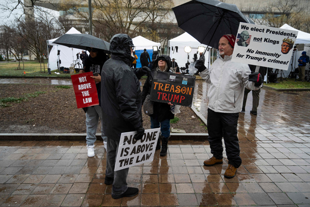 Protesters stand outside the E. Barrett Prettyman US Courthouse in Washington, DC, on Tuesday, during a hearing on immunity for former US president Donald Trump (AFP photo)