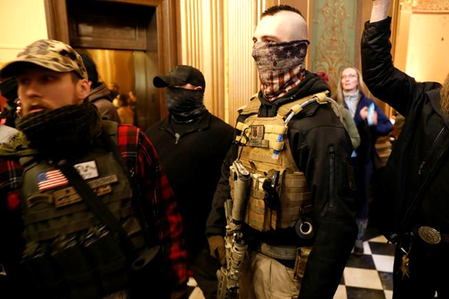 Armed protestors try to enter the Michigan state legislature to protest the coronavirus lockdown (AFP photo)