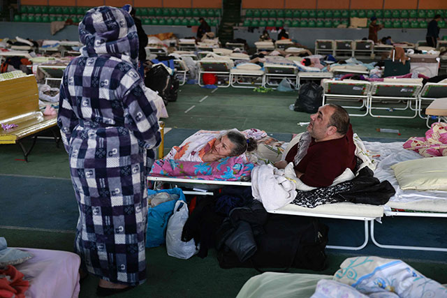 Ukrainians who fled the war in their country take refuge in the main hall of an athletic complex in the Moldovan capital Kishinev, on Thursday (AFP photo)