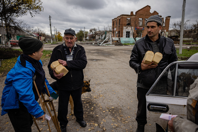 Local residents buy a bread in the village of Drobysheve in eastern Ukraine's Donetsk region, on Friday (AFP photo)
