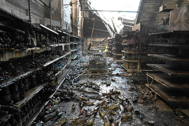 A photograph taken on Tuesday shows charred goods in a grocery store of the destroyed Amstor mall in Kremenchuk, one day after it was hit by a Russian missile strike, according to Ukrainian authorities (AFP photo)