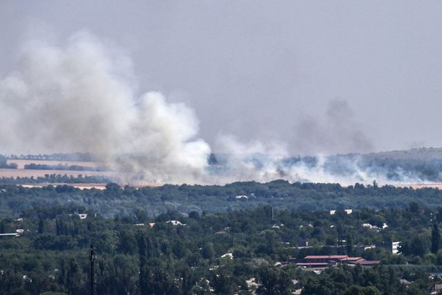 A photo taken on Thursday shows smoke billowing during an artillery exchange between Ukrainian army and Rusian army on the outskirts of the city of Sloviansk (AFP photo)