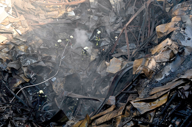 Firefighters intervene in the rubble of the Culture Palace destroyed by Russian missile strike in the second largest Ukrainian city of Kharkiv on Thursday (AFP photo)