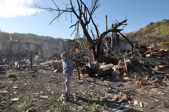 A local resident, walks past a house destroyed as a result of shelling in town in Kupiansk, Kharkiv region on Monday, as the Russia-Ukraine war enters its 236th day (AFP photo)