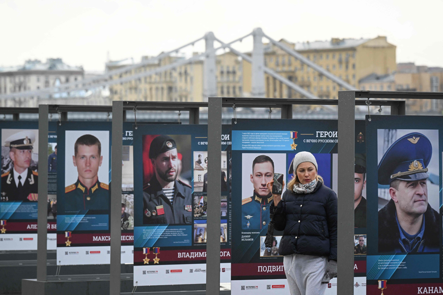 A woman looks at posters honouring Russian service members, including those participating in the ongoing military action in Ukraine, at the Muzeon Park in Moscow, on Wednesday (AFP photo)