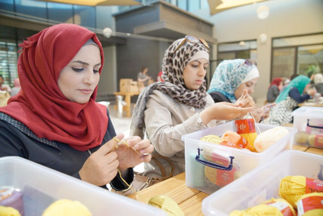 Rasha and Wesal practise some of the crochet handicraft skills they have learned (Photo courtesy of UNESCO)