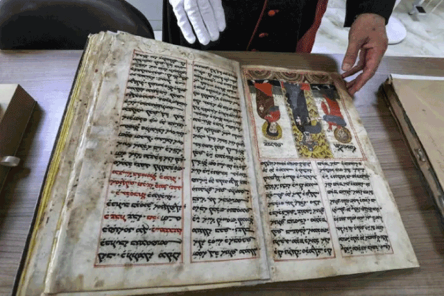 In this photo  taken on May 16, the Chaldean Catholic Archbishop of Mosul Michaeel Najeeb presents an old Syriac-language Christian codex at the Eastern Manuscript Digitisation Centre (CNMO) in Erbil, the capital of Iraq’s autonomous northern Kurdish region (AFP photo)
