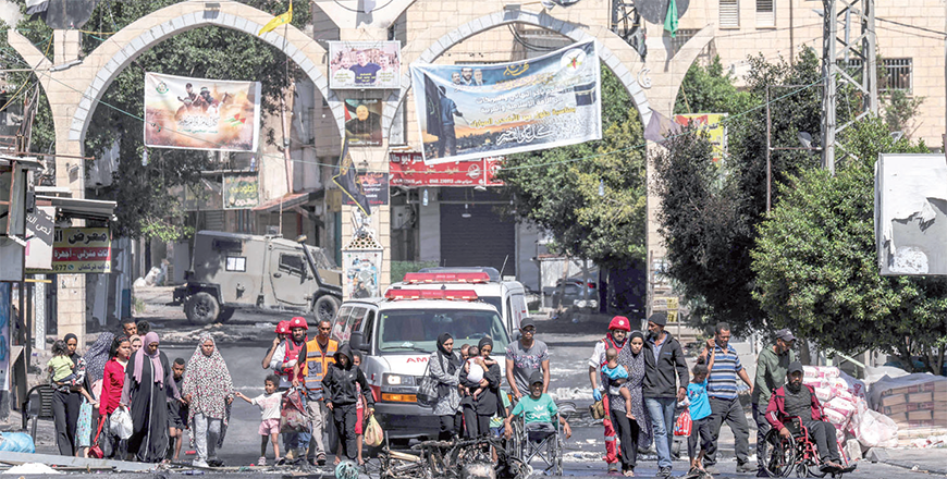 People flee the Jenin refugee camp in the occupied West Bank during an ongoing Israeli military operation on Tuesday (AFP photo)