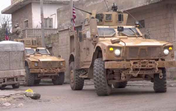 An image grab taken from a video obtained by AFPTV on Wednesday shows US armoured vehicles at the scene of a suicide attack in the northern Syrian town of Manbij (AFP photo)