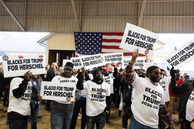 Members of 'Blacks for Trump' wave campaign signs during a rally for Republican Senate nominee Herschel Walker on Monday in Milton, Georgia (AFP photo)