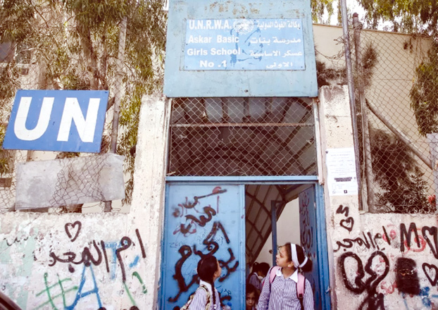 Palestinian girls outside a school run by UNRWA in the Askar refugee camp in Nablus (AFP file photo)