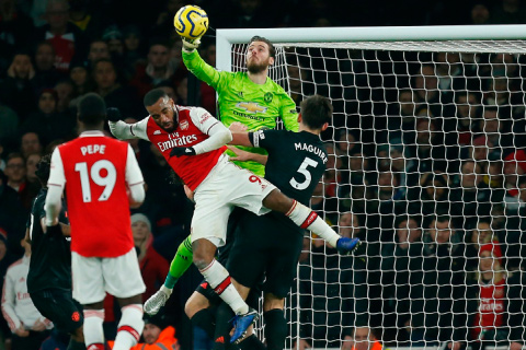 Manchester United’s Spanish goalkeeper David de Gea punches the ball clear during the English Premier League football match between Arsenal and Manchester United at the Emirates Stadium in London on Wednesday (AFP photo by Ian Kington)