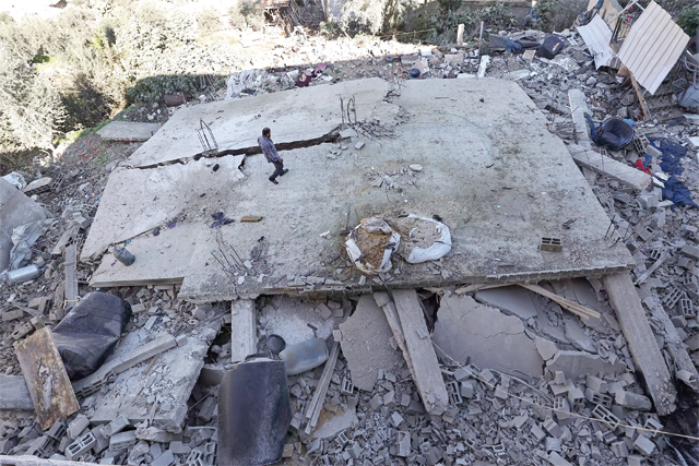 A man walks amid the rubble of a building destroyed during an Israeli forces raid in the Jenin refugee camp (AFP photo)
