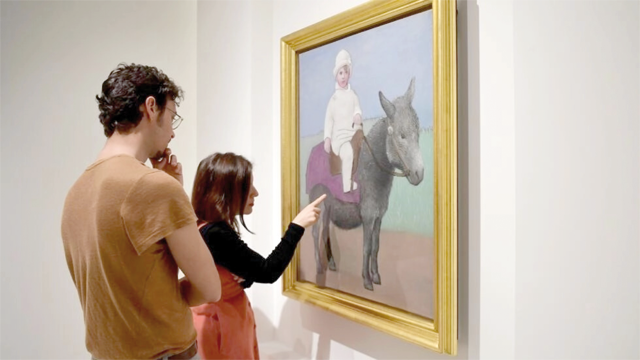Visitors look at an oil painting entitled ‘Paul on a donkey’ during the official unveiling of a new exhibition of works by Pablo Picasso at Malaga’s Picasso Museum (AFP photo)