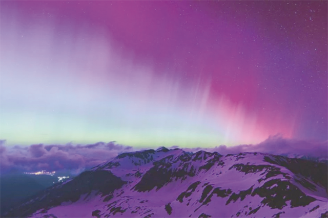 Northern lights or aurora borealis illuminate the night sky over Fusch an der Großglocknerstraße, near Zell am See, during a geomagnetic storm on Saturday (AFP photo)