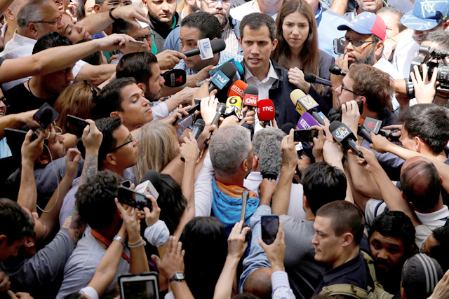 Venezuelan opposition leader and self-proclaimed interim president Juan Guaido accompanied by his wife Fabiana Rosales speaks to the media after a holy mass at a local church in Caracas, Venezuela, on Sunday (Reuters photo)