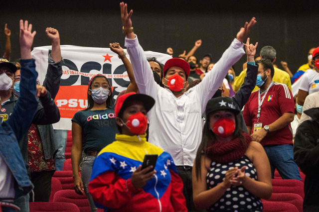 Supporters of the Socialist United Party of Venezuela (PSUV) react to the legislative election results in Caracas on Monday (AFP photo)
