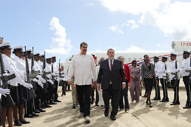 This handout photo released by the Venezuelan Presidency shows Venezuela's President Nicolas Maduro (left) talking with Prime Minister of Saint Vincent and the Grenadines Ralph Everard Gonsalves (right) after his arrival at the Argyle International Airport in Saint Vincent and The Grenadines on Thursday (AFP photo)