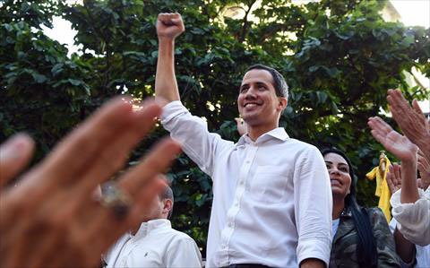 Venezuelan opposition leader and self-proclaimed acting president Juan Guaido raises his fist after a rally in Caracas, on Sunday (AFP photo)