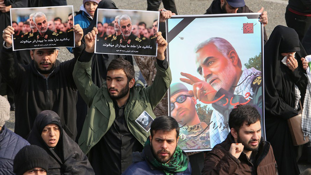 Iranians hold posters of Iranian Revolutionary Guards Major General Qassem Soleimani in the capital Tehran on Friday (AFP photo)