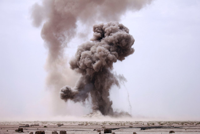 Smoke billows during controlled explosions by a Yemeni military demining unit to destroy unexploded bombs and mines collected from conflict areas near the southern port city of Aden, Yemen, on Tuesday (Reuters photo)