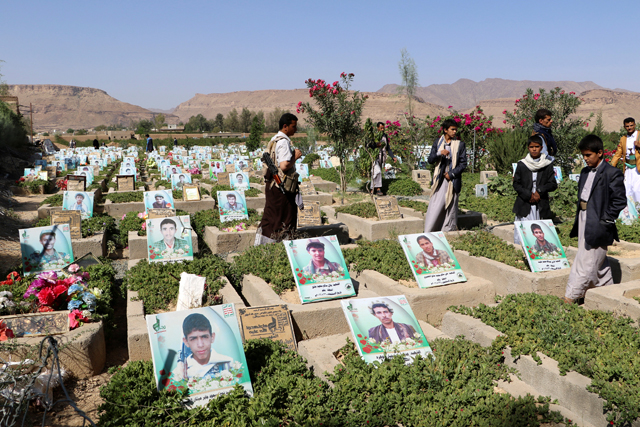 People visit a graveyard allocated for Houthi fighters killed in the ongoing Yemeni conflict in the northwestern city of Saada, Yemen, on Sunday (Reuters photo)