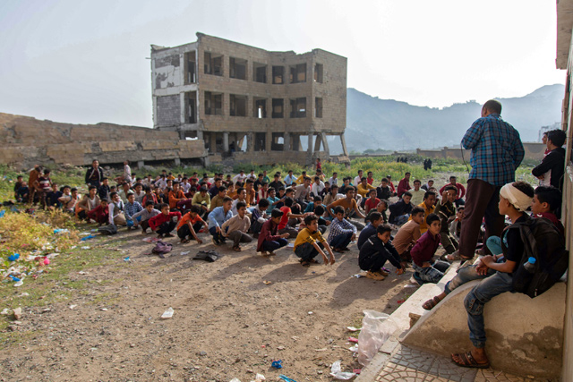 Yemeni students attend class in their destroyed school compound on the first day of the new academic year in the country's third-city of Taez on Monday (AFP photo)