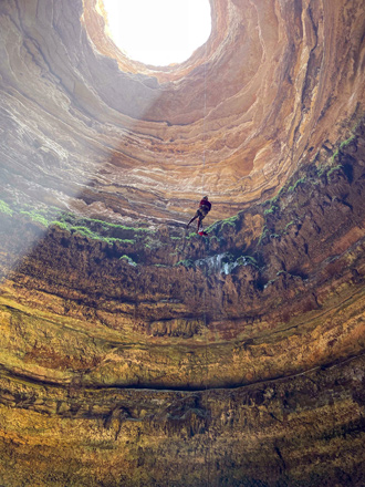 This handout photo taken by the Oman Cave Exploration Team on September 15 shows one of the team’s cavers abseiling down the Barhout well, a sinkhole known as the ‘Well of Hell’ in the desert of Yemen’s Al Mahra province (AFP photo)