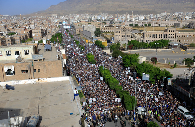 Yemenis loyal to Houthi rebels take part in a rally marking the seventh anniversary of the Saudi-led coalition's intervention in their country, in the capital Sanaa, on Saturday (AFP photo)