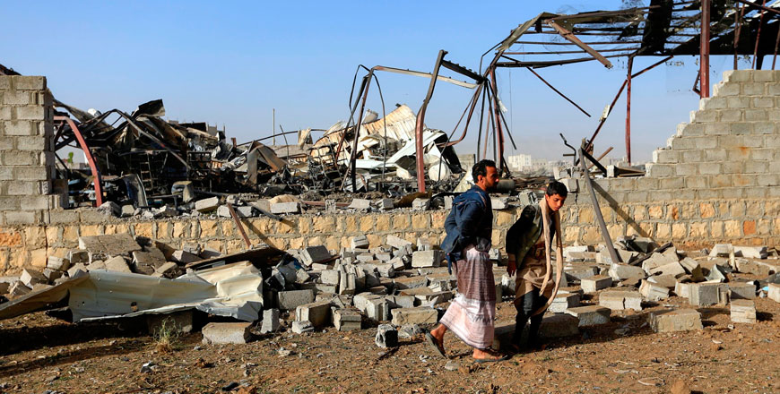Civilians inspect the damage at a factory after a reported air strike by Saudi-led coalition in the Yemeni capital Sanaa, on Sunday (AFP photo)
