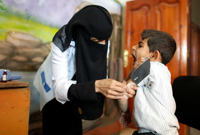 A boy reacts as he receives a vaccination for measles and rubella at his school as a six-day immunisation campaign kicks off in Sanaa, Yemen, on Saturday (Reuters photo)