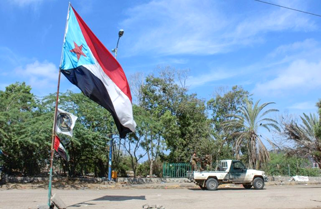 Fighters with Yemen's Southern Transitional Council drive past a separatist flag -- the flag of the former nation of South Yemen -- in the city of Aden (AFP photo)