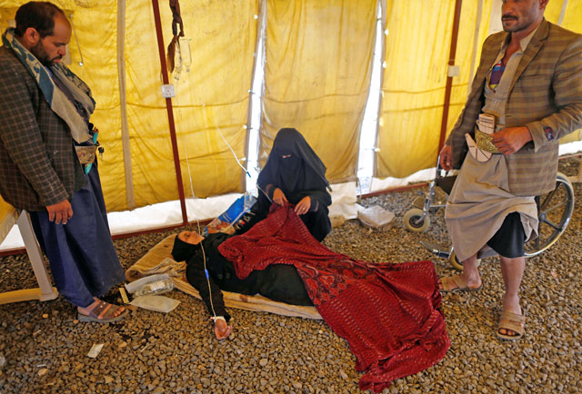 A woman suffering from cholera lies on the ground in a tent as she waits for medical care at a cholera treatment centre in Sanaa, Yemen, on March 10 (Reuters photo)