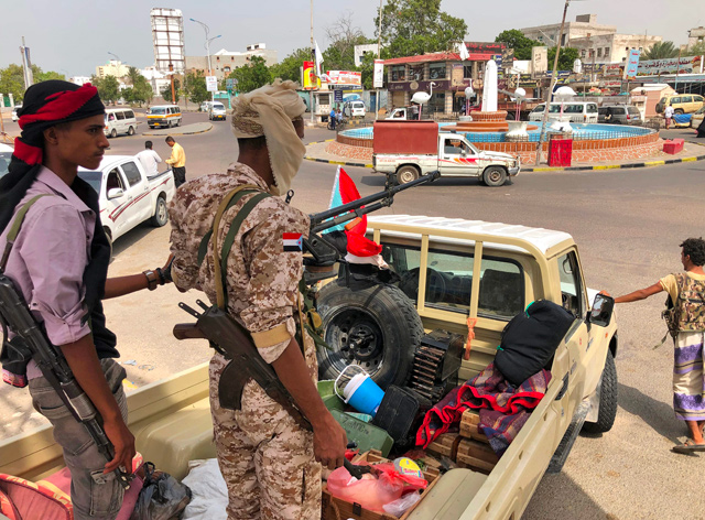 A fighter of the Security Belt Force, dominated by backers of the the Southern Transitional Council which seeks independence for south Yemen, mans the pickup truck mounted with an anti-aircraft gun in the centre of Yemen’s second city of Aden, on Monday  (AFP photo)