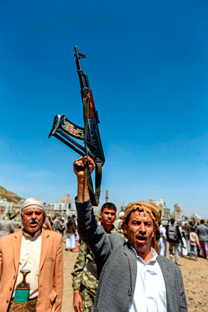 A Yemeni man chants slogans as he holds up a Kalashnikov assault rifle during a tribal meeting in the Houthi rebel-held capital Sanaa on Saturday, as tribesmen donate rations and funds to fighters loyal to the Houthis  (AFP photo)