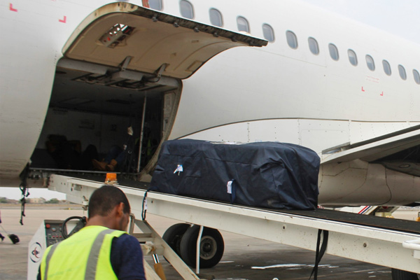 A worker unloads the coffin of Yemeni kung fu champion Hilal Al Haj, who drowned in the Mediterranean, upon its arrival at Aden International Airport in Yemen's second city of Aden, on Thursday (AFP photo)
