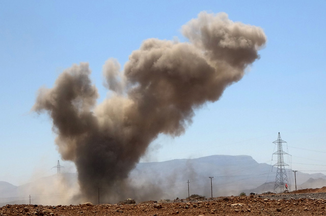   A smoke plume rises following an explosion as forces loyal to Yemen’s Saudi-backed government clash with Houthi rebel fighters around the strategic government-held ‘Mas Camp’ military base, in Al Jadaan area about 50 kilometres northwest of Marib in central Yemen, on Sunday (AFP photo)