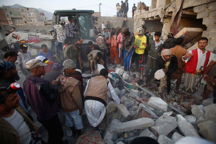 People search for survivors under the rubble of houses destroyed by Saudi air strikes in Sanaa, Yemen, Monday (AP photo)