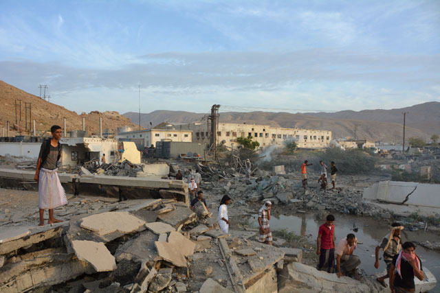 People inspect damage at a site hit by Saudi-led air strikes in Al Qaeda-held port of Mukalla city in southern Yemen on Sunday (Reuters photo)