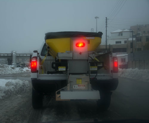 A Greater Amman Municipality vehicle sprays salt on a road in the capital in January of this year. The municipality said on Sunday it has added 17 salt spreader trucks to its winter fleet (Photo by Amjad Ghsoun)