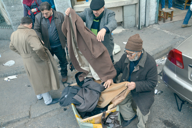 A vendor is seen selling second-hand clothes in downtown Amman in this photo taken on January 19, 2017 (Photo by Amjad Ghsoun)