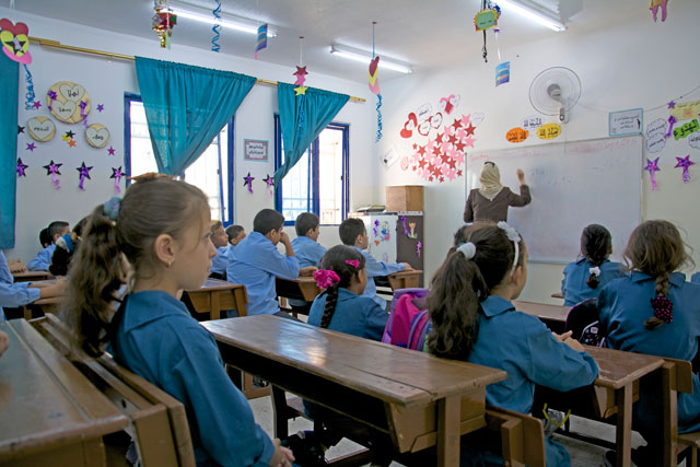 In this undated photo, students attend a class at a private school in Amman (Photo by Amjad Ghsoun)