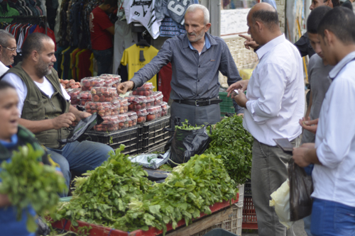 A photo shows Jordanians buying vegetables downtown Amman recently (Photo by Amjad Ghsoun)