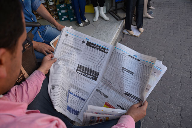 A man reads Al Rai newspaper in Amman on Sunday (Photo by Amjad Ghsoun)