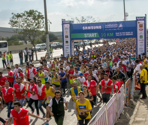 Runners take off from the start of the Samsung Amman Marathon 10km race on Friday in Amman (Photo by Amjad Ghsoun)