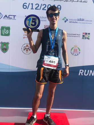 Hasan Tayem poses with his trophy after finishing first in the Ayla Red Sea Half Marathon (Photo courtesy of Hasan Tayem)
